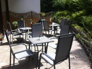a row of tables and chairs on a patio at Hotel Quellenhof - Self-Check-in in Bad Urach