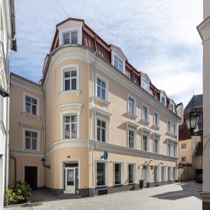 a large building in the middle of a street at Konventa Sēta Hotel Keystone Collection in Riga