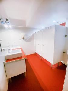 a bathroom with white cabinets and an orange floor at Transit 77 in Istanbul