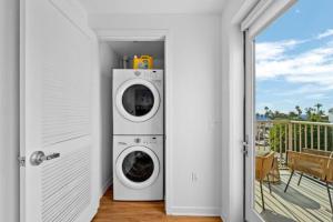 a washer and dryer in a room with a balcony at Downtown Santa Monica Top Floor Ocean View 2BR/2BA in Los Angeles