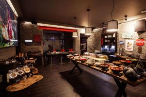 a restaurant with a lot of food on a table at Konventa Sēta Hotel Keystone Collection in Riga