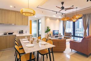 a kitchen and living room with a table and chairs at ❈ Tropicana 218 by ALV Suites ❈ in George Town