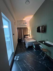 a hotel room with a bed and a desk at GUEST INN HOTEL in Dubai