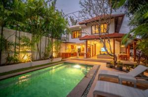 a house with a swimming pool in front of a house at Villa Jado 2 - 3 Bedroom Villa With Private Pool in Kerobokan