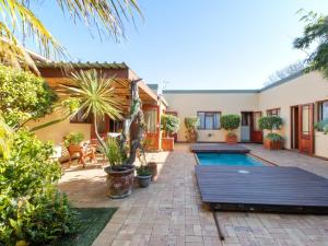 a house with a swimming pool in a yard at Dai Heka Guest House in Strand