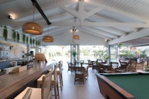 a restaurant with tables and a pool table at Mirage Studios in Malia