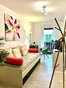 a living room with a couch with red pillows at Privatzimmer Hanna in Dießen am Ammersee