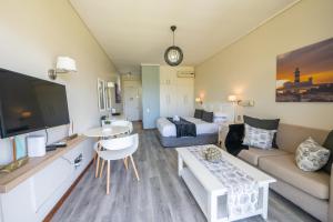 a living room with a bed and a couch at Unit 261 Brookes Hill Suites in Summerstrand