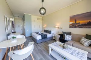 a hotel room with a bed and a couch at Unit 261 Brookes Hill Suites in Summerstrand