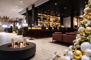 a lobby with a bar and a christmas tree at Hilton Garden Inn Vilnius City Centre in Vilnius