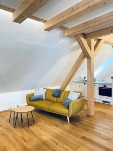 a living room with a yellow couch and a table at Destino in Sulzbach-Rosenberg