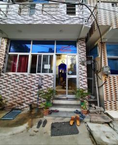 a front door of a house with a person in the doorway at Goroomgo Pranab Sadan Puri in Puri