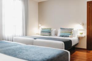 Postel nebo postele na pokoji v ubytování Oriente Atiram Hotel