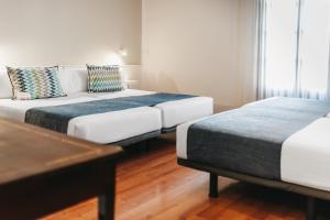 Postel nebo postele na pokoji v ubytování Oriente Atiram Hotel
