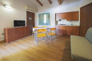 a kitchen with a table and chairs in a room at Heliopolis Camping & Village in Pineto