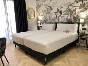 Postel nebo postele na pokoji v ubytování Oriente Atiram Hotel