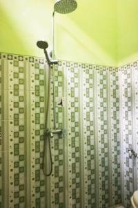 a shower in a bathroom with a shower curtain at Hotel Antik in Soreang
