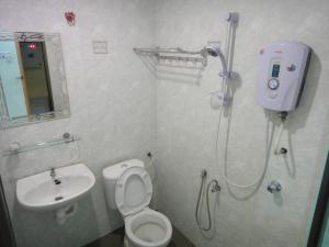 话毛生美茵旅馆酒店的带淋浴、马桶和水槽的浴室