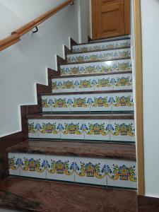 a set of stairs with blue and white tiles at La Replaceta in Chulilla