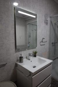 a bathroom with a sink and a mirror and a shower at La Replaceta in Chulilla