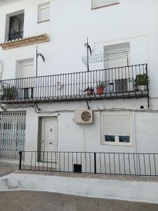a white building with balconies on the side of it at La Replaceta in Chulilla