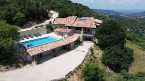 an aerial view of a house with a swimming pool at La Ferme d'Helyette in Toulaud