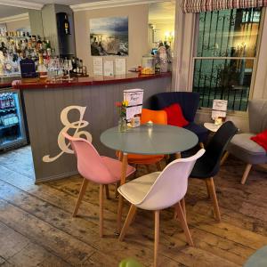 a table and chairs in front of a bar at Ebenezer's Place in Broadstairs