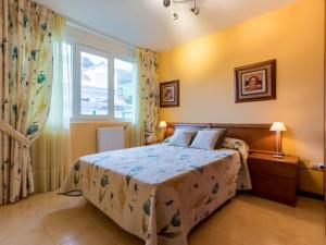 a bedroom with a bed and a large window at Holiday Home La Joya by Interhome in Boó de Piélagos