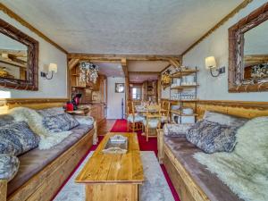 a living room with couches and a table at Apartment Belleville Caron-5 by Interhome in Les Menuires