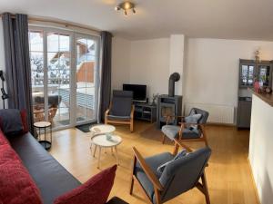 a living room with a couch and chairs at Apartment Top 4 by Interhome in Sankt Margarethen im Lungau