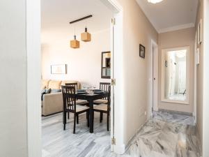 a dining room and living room with a table and chairs at Apartment Bellavista del Puerto by Interhome in Estepona +24 photos