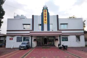 a building with a car parked in front of it at Hotel Kumkum Chhaya in Panna