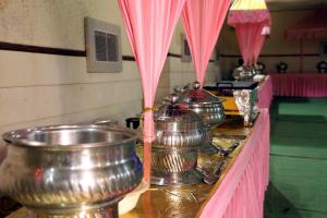 una fila de hervidores de metal sobre una mesa en Hotel Kumkum Chhaya, en Panna