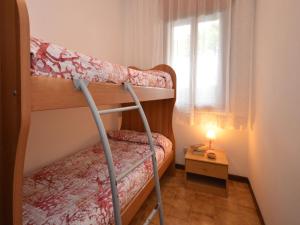 a bedroom with two bunk beds and a window at Apartment Orsa Maggiore by Interhome in Lignano Sabbiadoro +11 photos