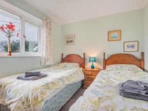 two twin beds in a bedroom with a window at 3 Bed in Threlkeld SZ047 in Threlkeld