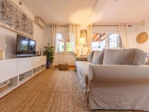 a living room with a couch and a tv at Holiday Home Villa Jardin by Interhome in Vilafortuny