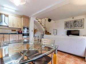 a kitchen and living room with a glass table at Holiday Home Villa Jardin by Interhome in Vilafortuny