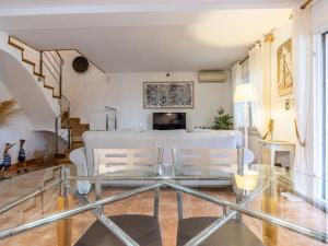 a living room with a glass table and chairs at Holiday Home Villa Jardin by Interhome in Vilafortuny +34 photos