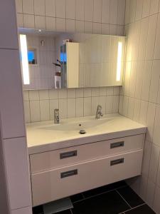 a bathroom with a sink and a mirror at Tromsø’s best location? City & Nature 5 mins away. in Tromsø