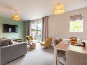 a living room with a couch and a table at 2 Bed in St. Mellion 87703 in St Mellion