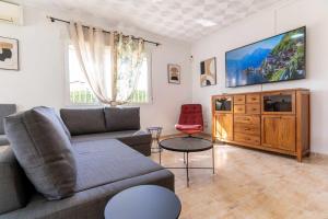 a living room with a couch and a tv at rentafive - Nuevo - A/A - Barbacoa - Tenis in Santa Pola
