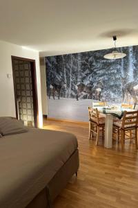 a bedroom with a bed and a table and chairs at Studio Frassan Apartments-3 by Interhome in Madonna di Campiglio