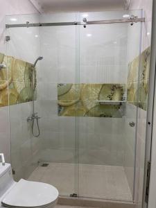 a bathroom with a glass shower with a toilet at Big villa, new, near center in Ho Chi Minh City