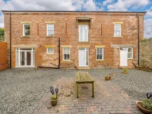 a brick building with a table in front of it at 2 Bed in Askam - in - Furness 88651 in Ireleth