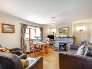 a living room with a table and a fireplace at 2 Bed in Barmouth 89393 in Dyffryn