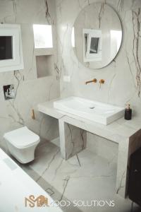 a white bathroom with a sink and a toilet at FirstLineSkg3 Moodsolutions Living in Thessaloniki +10 photos