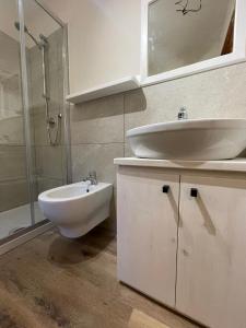 a bathroom with a sink and a toilet and a shower at Maison Marcel Sarre in Aosta