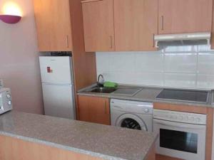 a kitchen with a white refrigerator and a dishwasher at Apartamento Miami Playa, 2 dormitorios, 4 personas - ES-9-152 in Hospitalet de l'Infant