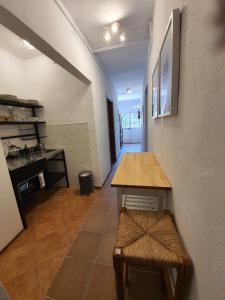 a kitchen with a table and a bench in a room at Molino de Las Pilas - Ecoturismo - Caminito del Rey in Teba