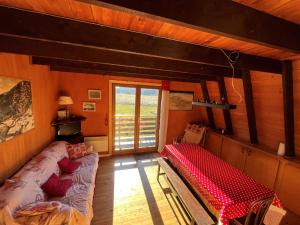 a living room with a couch and a red bench at Chalet atypique de charme pour 6 pers - FR-1-761-33 in Villard-de-Lans +4 photos